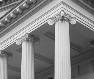 Close-up of classical building columns symbolizing trust and stability, reflecting how AV enables accounting firms to automate financial and investment reporting with accuracy and efficiency.