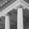 Close-up of classical building columns symbolizing trust and stability, reflecting how AV enables accounting firms to automate financial and investment reporting with accuracy and efficiency.
