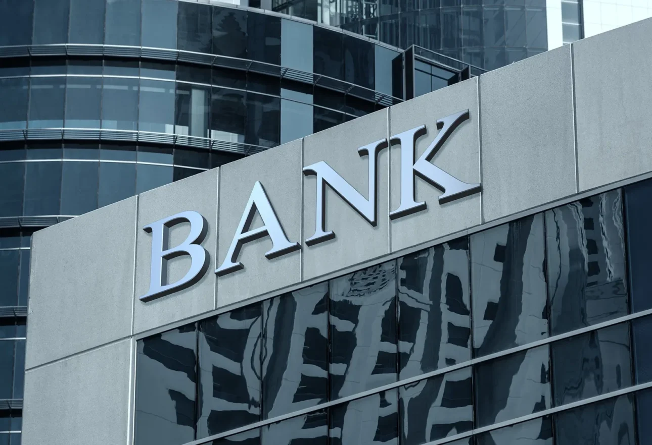 Modern bank building exterior with bold signage, representing how AV enabled a top tier private bank to launch a global-ready Digital Family Office platform for seamless wealth management and innovation.