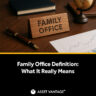 Image of a wooden 'FAMILY OFFICE' nameplate on a desk with a pen, globe, and a financial chart. Highlights the definition and importance of family offices in managing wealth and generational impact.
